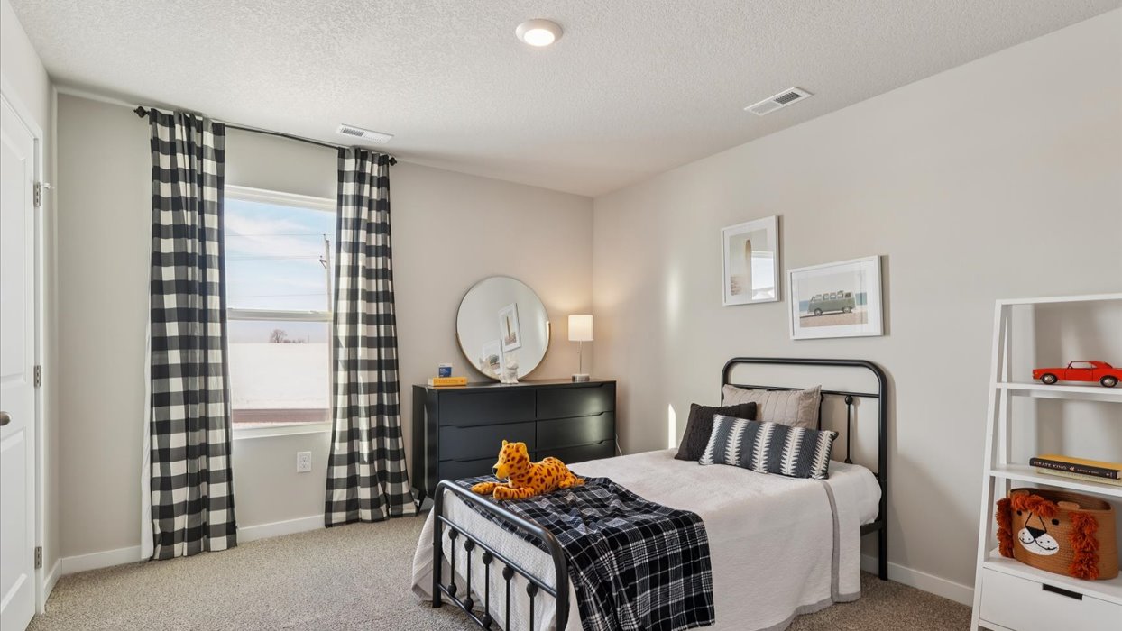 Comfortable secondary bedroom with natural light, modern finishes, and versatile living space.