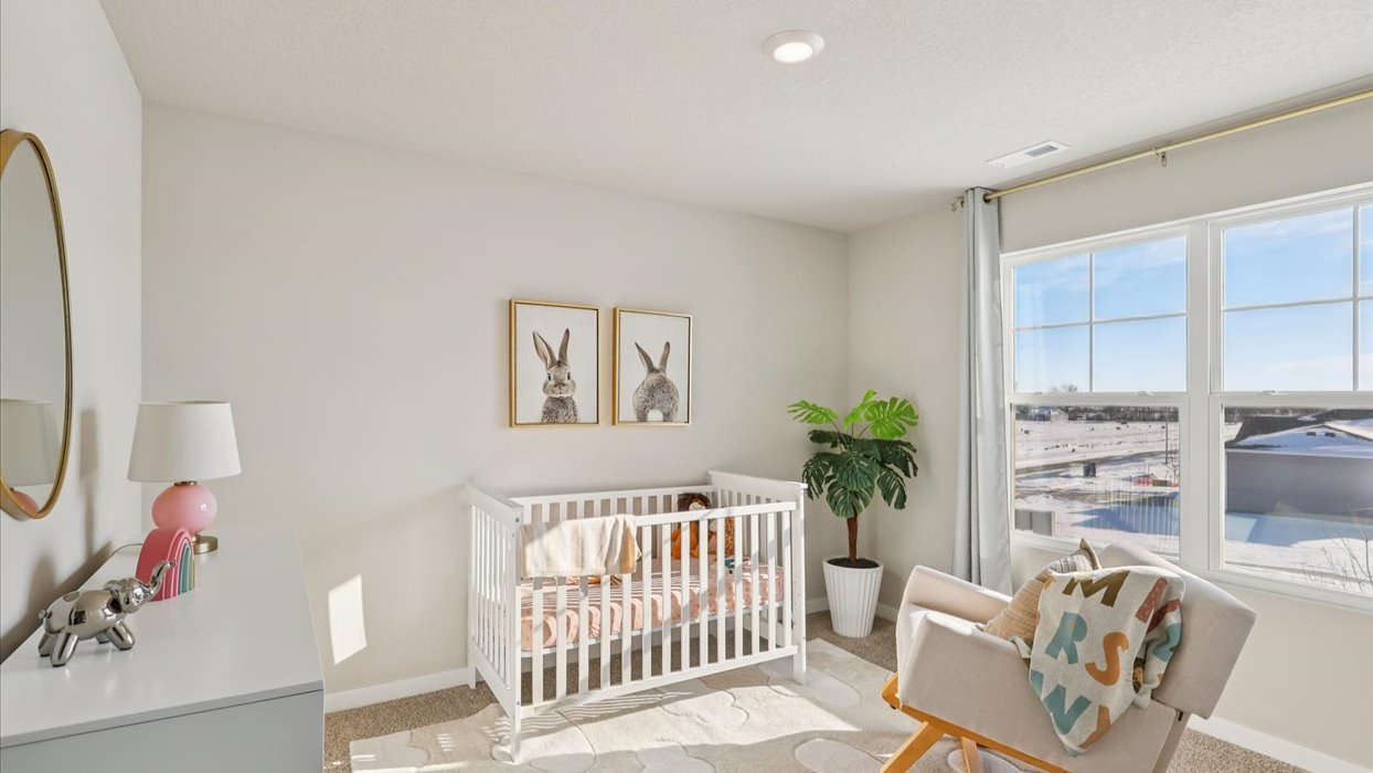 Comfortable secondary bedroom with natural light, modern finishes, and versatile living space.