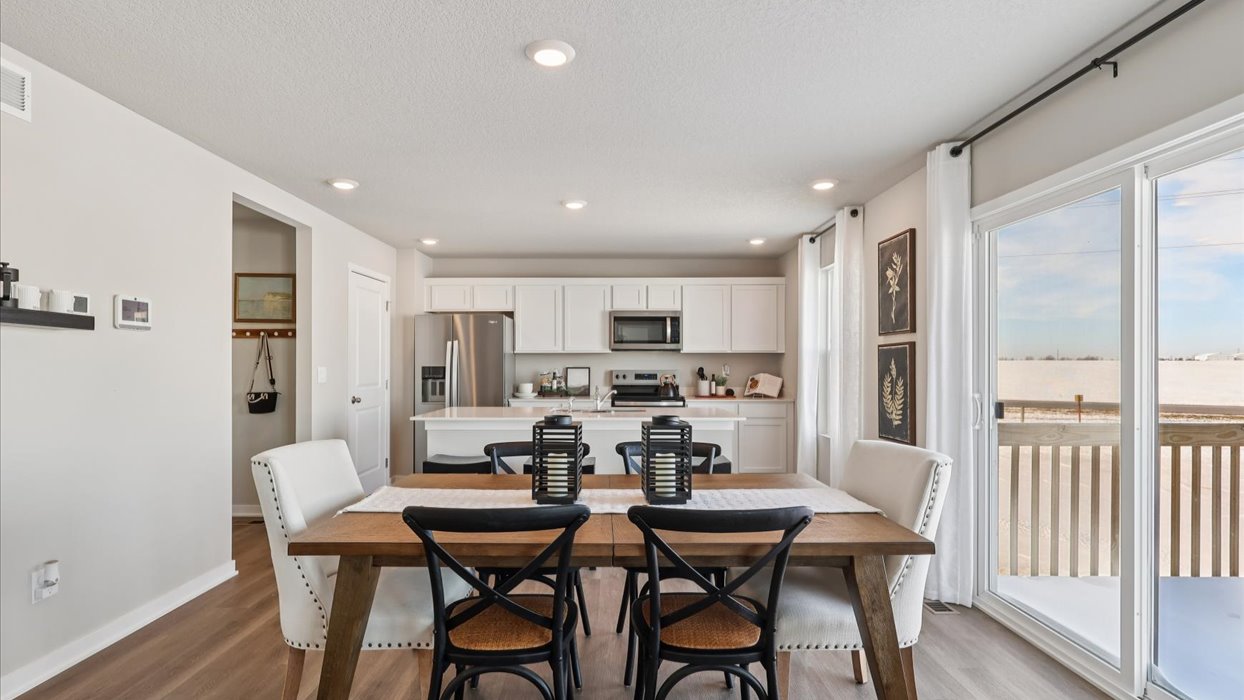 Open concept dining space with access to backyard