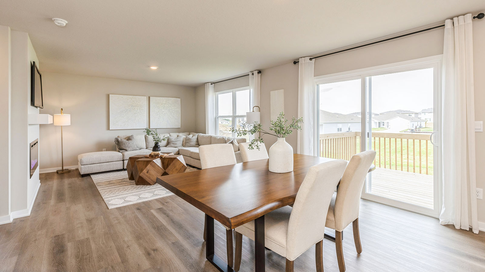View from kitchen to living room and backyard, highlighting our open-concept sleek design