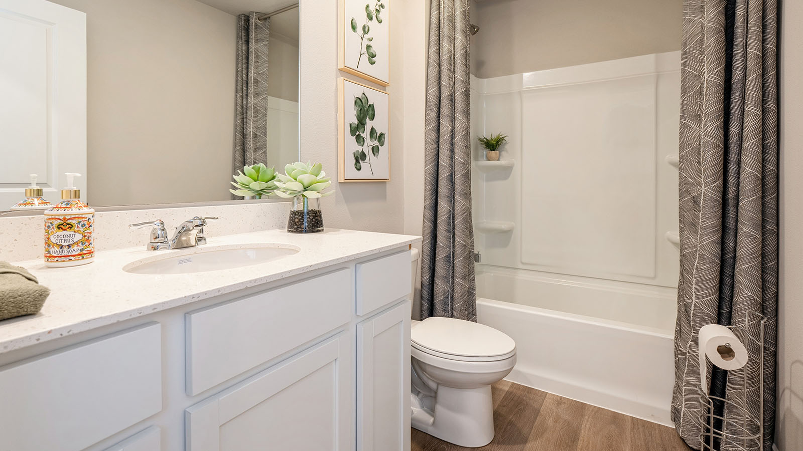 Bathroom with tub and shower combo, quartz countertops, and white vanity