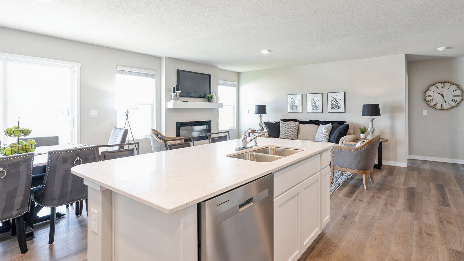 Kitchen with stainless steel appliances, quartz countertops, and white cabinetry