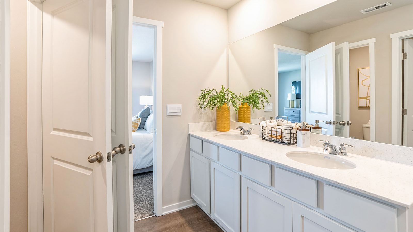Spacious bathroom with white cabinetry and double sinks