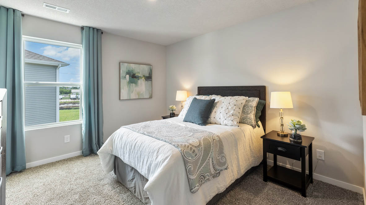 Comfortable secondary bedroom with natural light, modern finishes, and versatile living space.