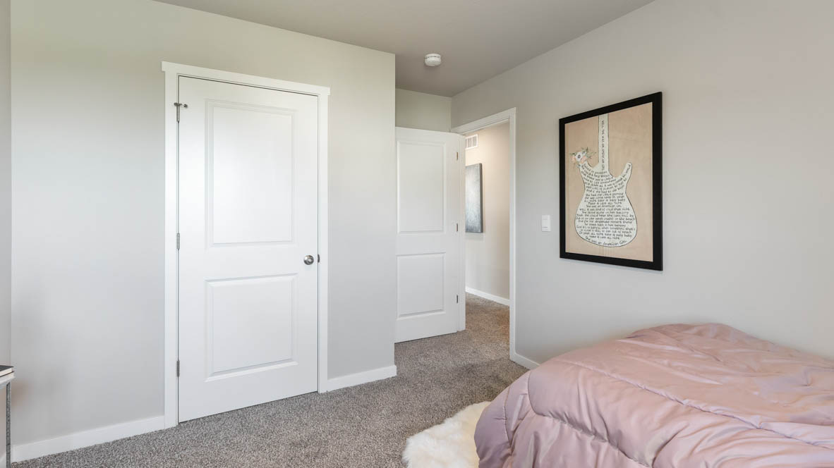 Comfortable secondary bedroom with natural light, modern finishes, and versatile living space.