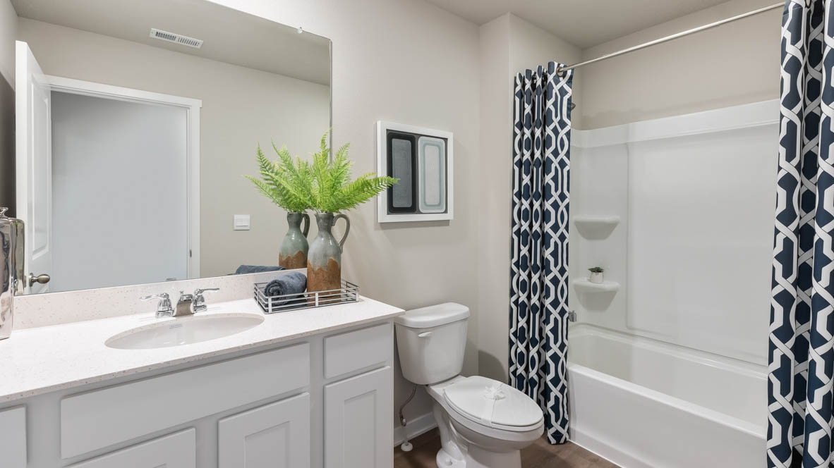 Bathroom with tub and shower combo, quartz countertops, and white vanity