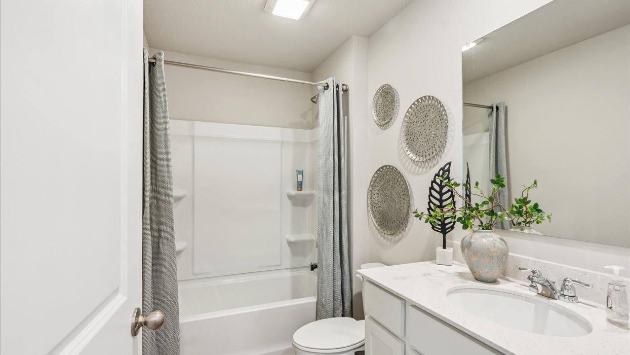 Stylish full bathroom with bright lighting and functional design.
