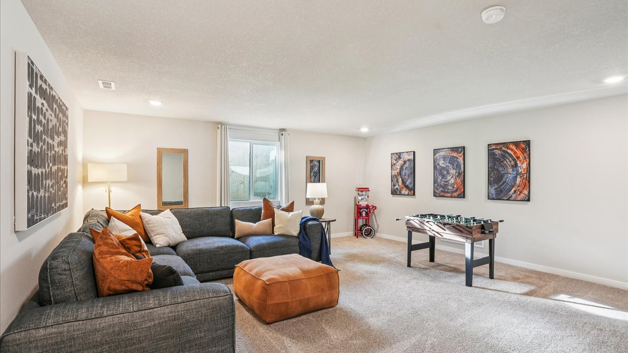 Finished basement living area with comfortable seating space and flexible room for entertaining or relaxing.