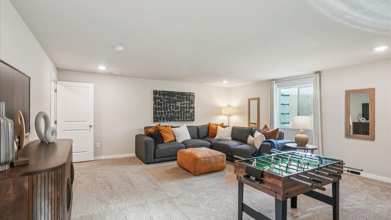 Finished basement living area with comfortable seating space and flexible room for entertaining or relaxing.