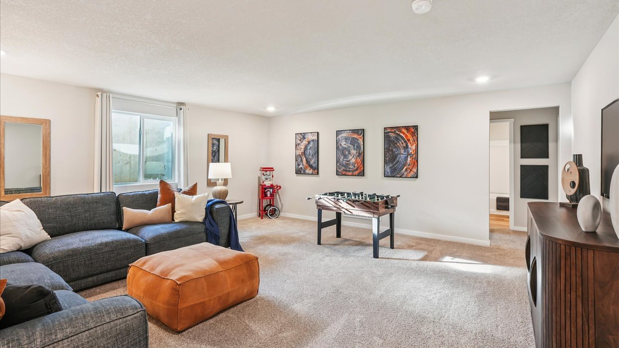 Finished basement living area with comfortable seating space and flexible room for entertaining or relaxing.