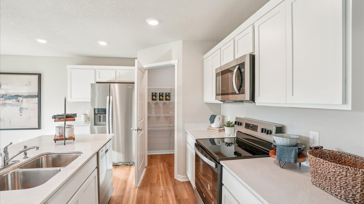Kitchen with white cabinetry and quartz countertop