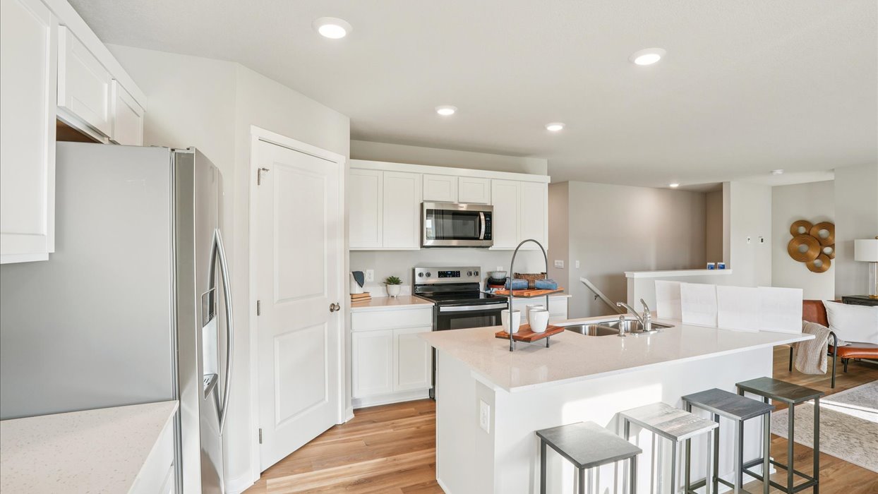 Kitchen with white cabinetry and quartz countertop
