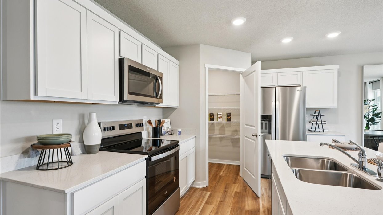 Kitchen with white cabinetry and quartz countertop