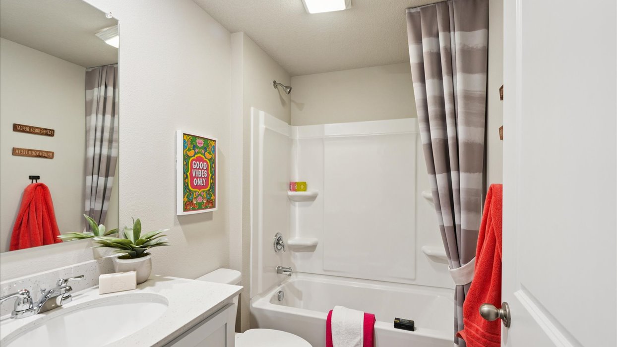 Stylish full bathroom with bright lighting and functional design.