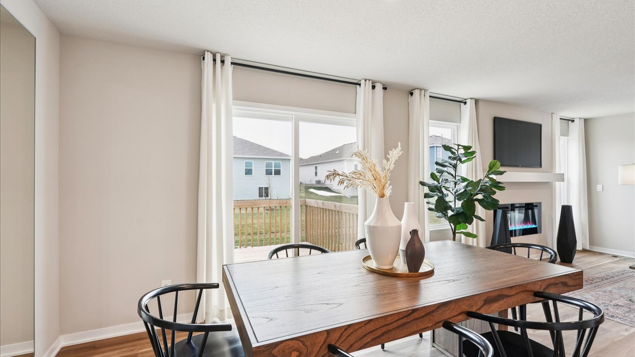 Open concept dining space with access to backyard
