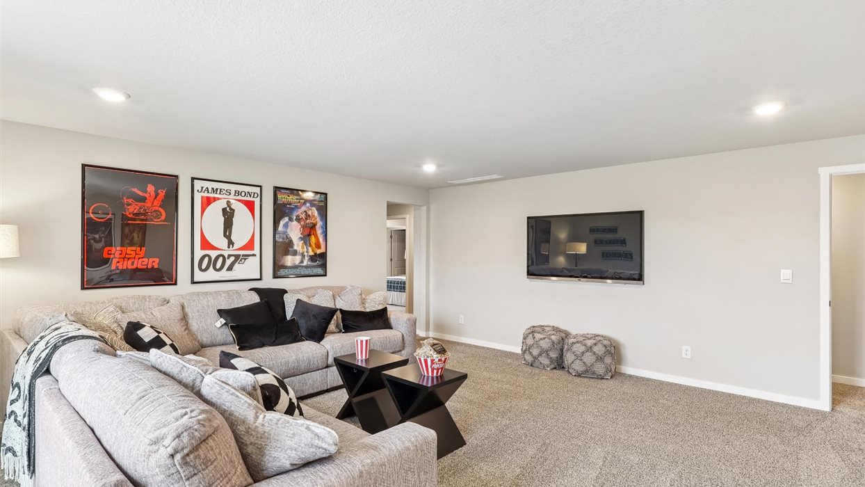 Finished basement living area with comfortable seating space and flexible room for entertaining or relaxing.