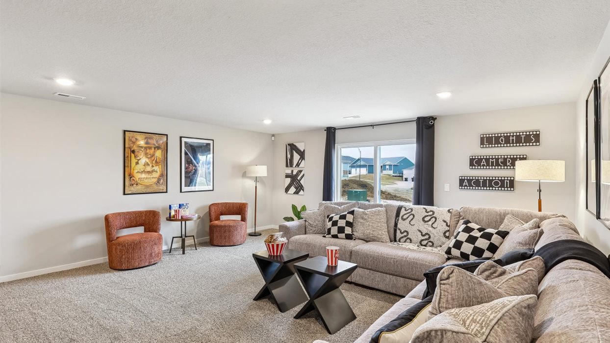 Finished basement living area with comfortable seating space and flexible room for entertaining or relaxing.