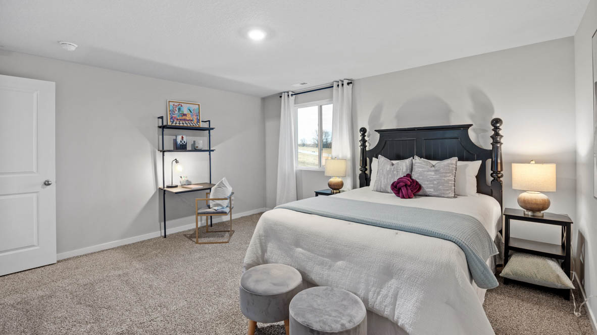 Private lower-level bedroom with natural light and functional storage space.