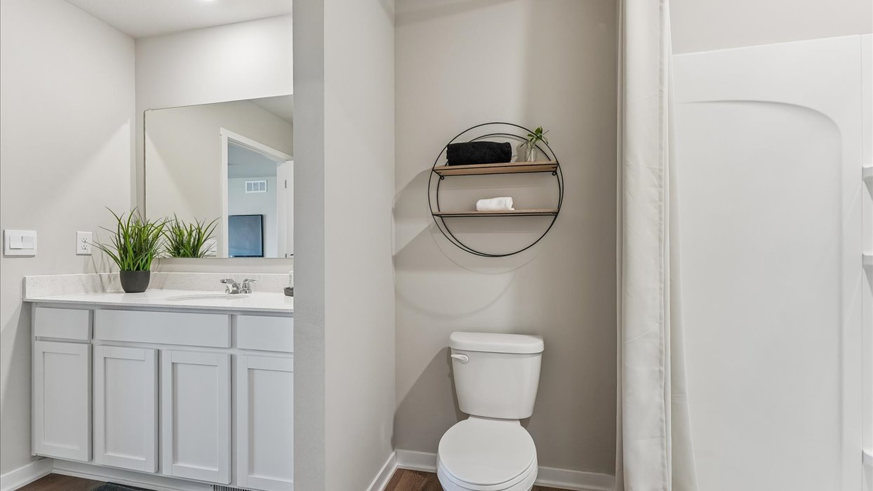 Stylish full bathroom with bright lighting and functional design.
