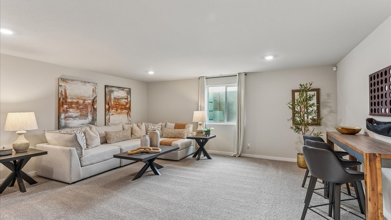 Finished basement living area with comfortable seating space and flexible room for entertaining or relaxing.