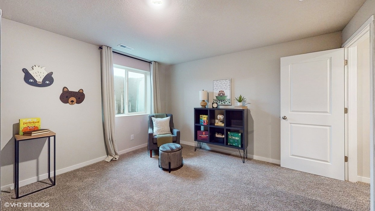 Private lower-level bedroom with natural light and functional storage space.