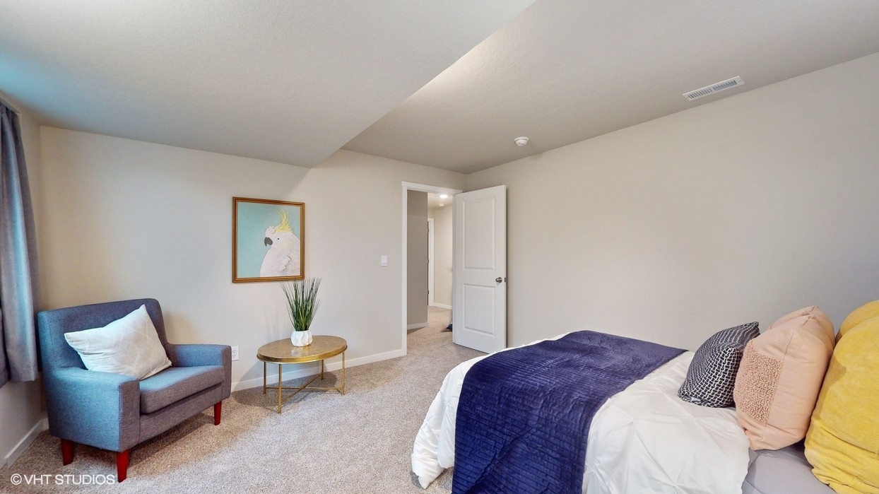 Private lower-level bedroom with natural light and functional storage space.