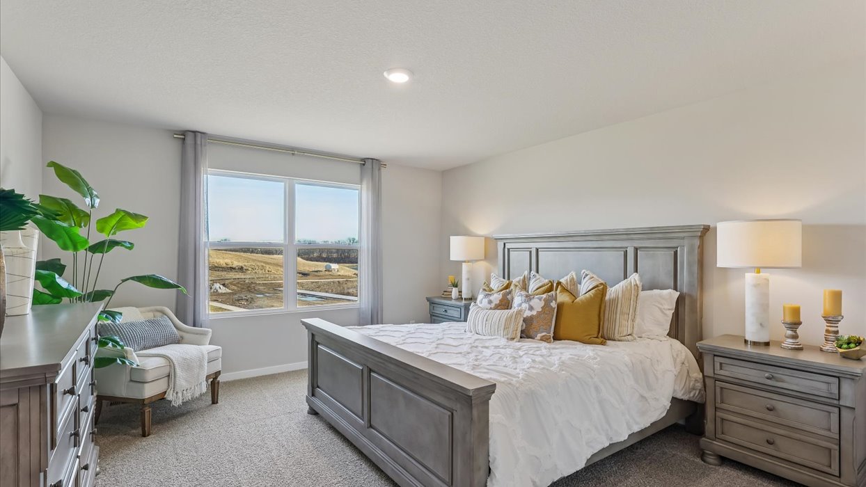 primary bedroom with large mirror and white bed