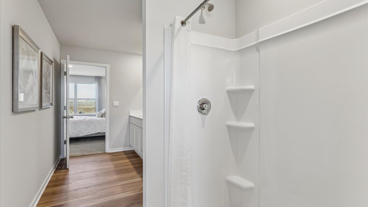 Spacious bathroom with white cabinetry and double sinks