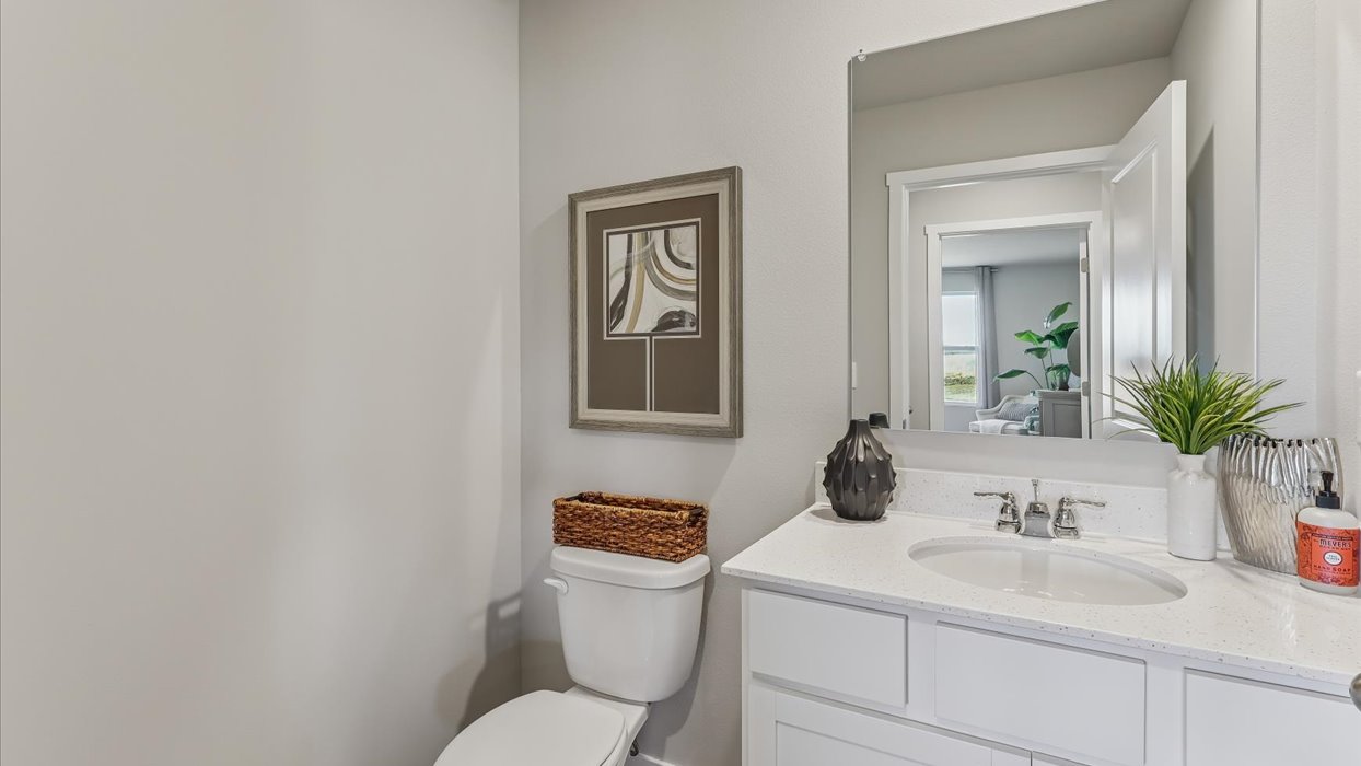 Convenient main-level powder room with updated fixtures and bright lighting.
