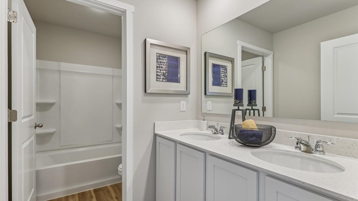 Stylish full bathroom with bright lighting and functional design.