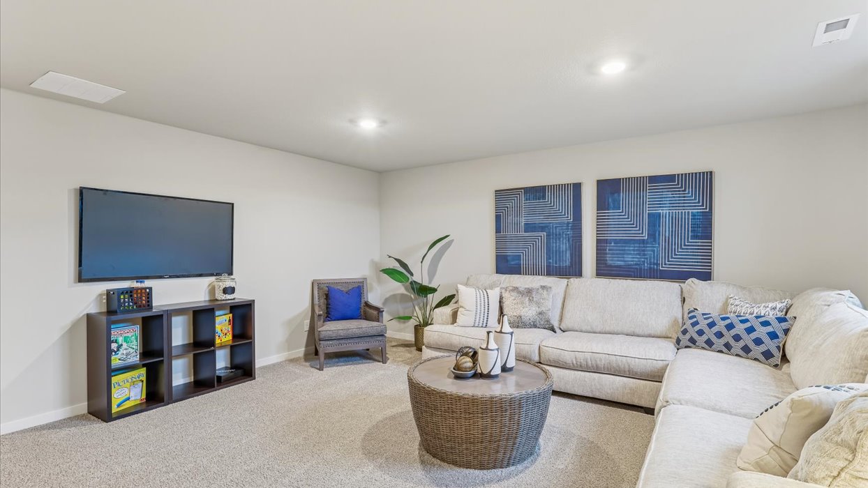 Finished basement living area with comfortable seating space and flexible room for entertaining or relaxing.