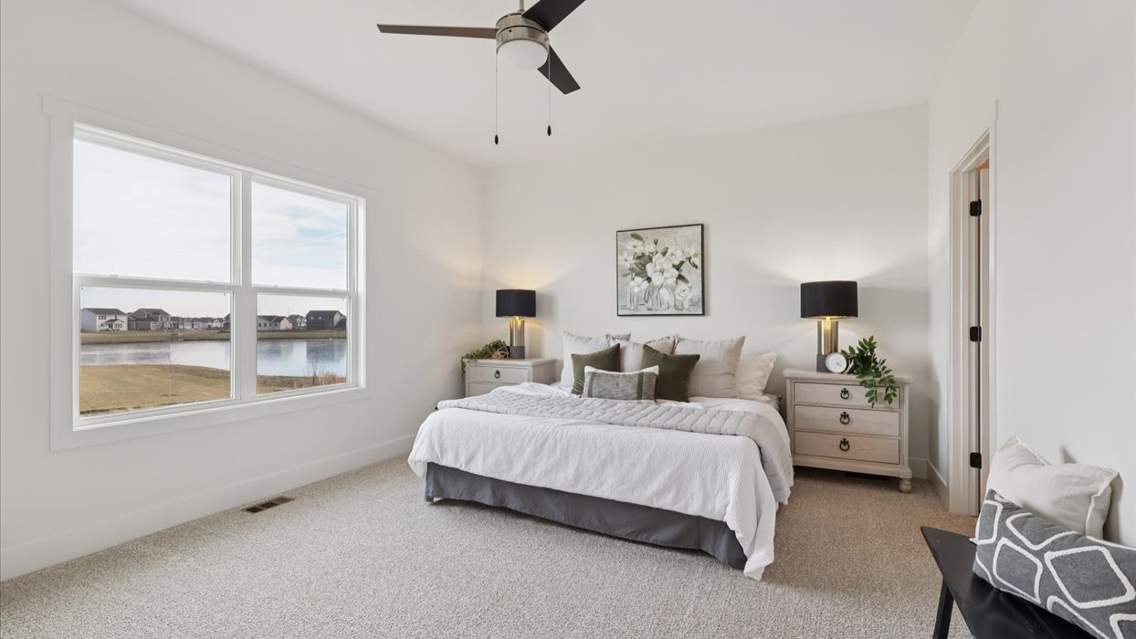 fairfield primary bedroom with large window and ceiling fan