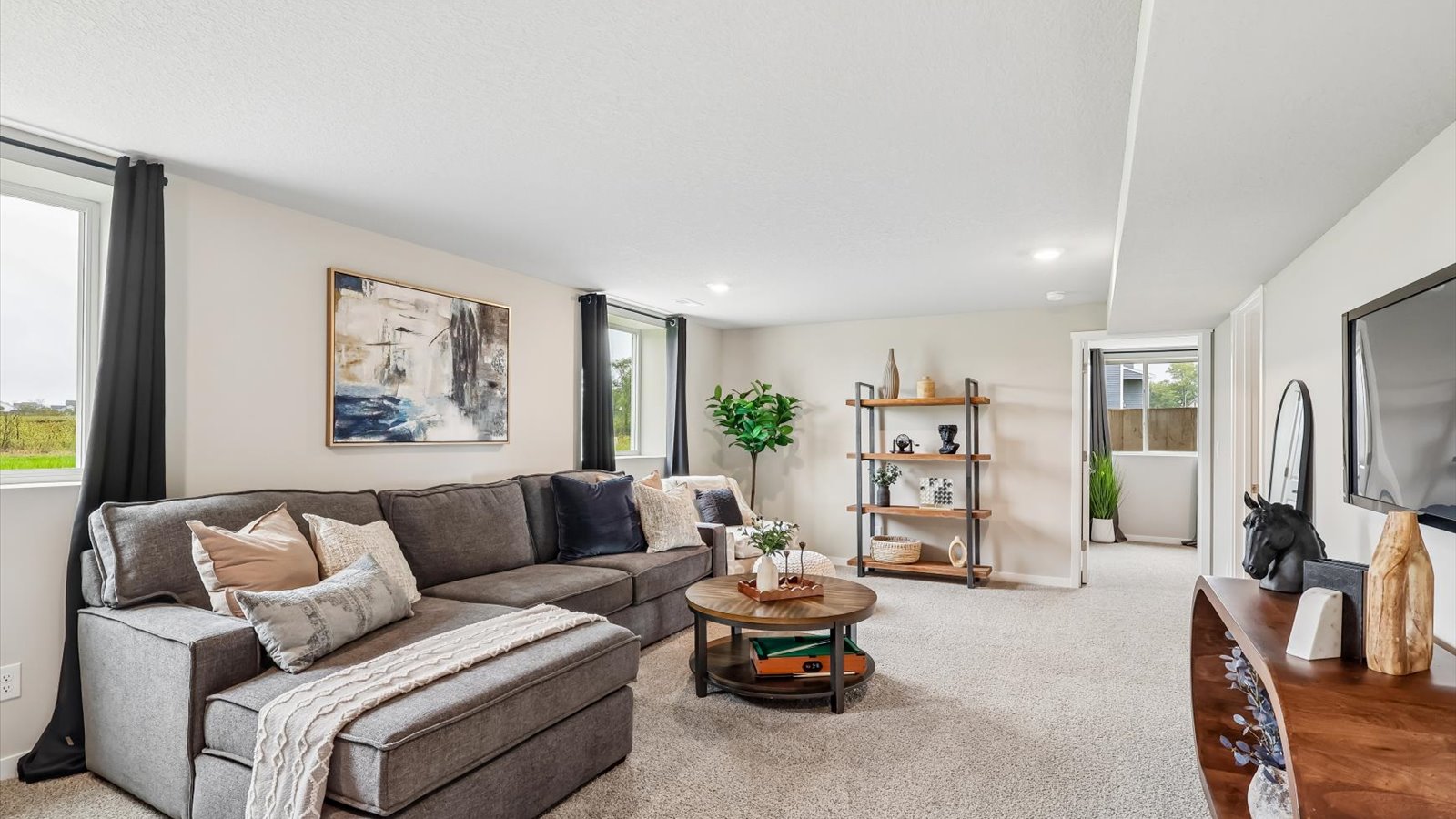 Finished basement living area with comfortable seating space and flexible room for entertaining or relaxing.
