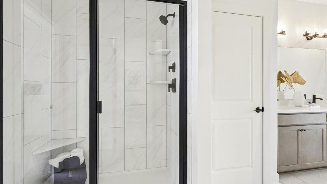 Owner’s en suite adds stylish appeal, spa-inspired design, and access to the primary bedroom and walk-in shower