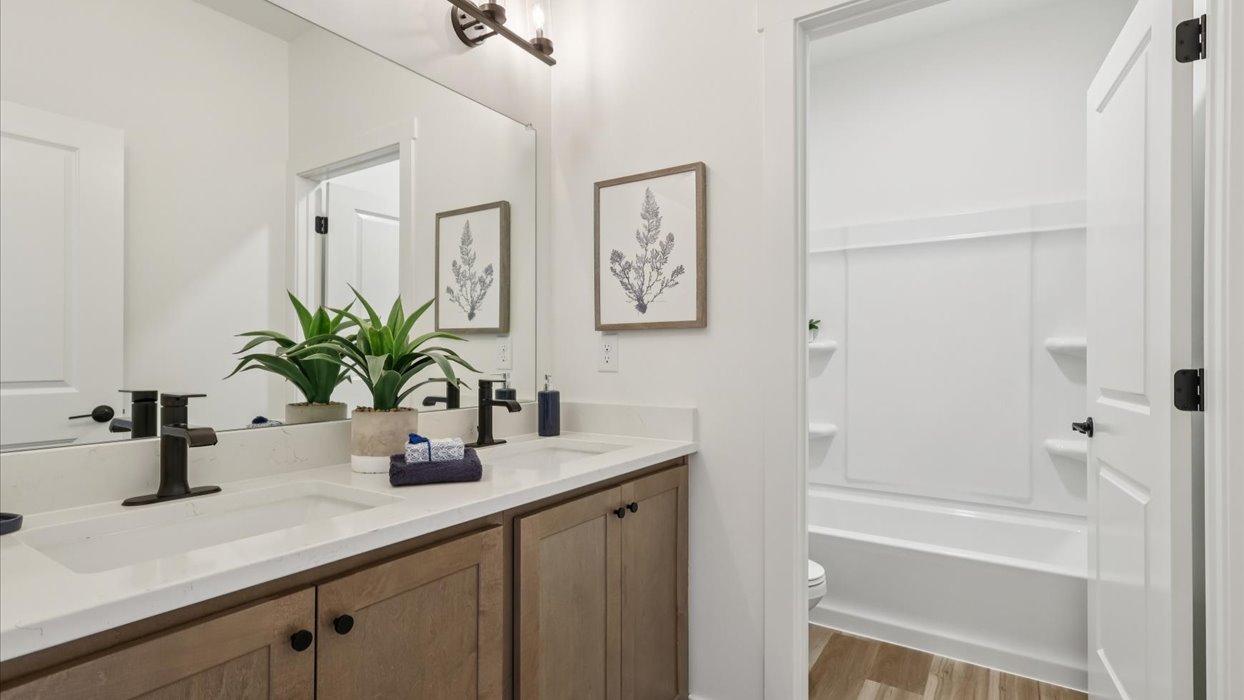 Family full bathroom 2, stylish vanity, mirror, refined fixtures, cabinets, upmarket tub-shower combo