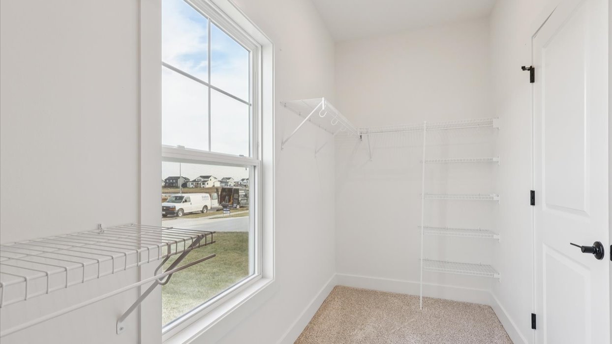 Interior view of the walk-in closet connected to the primary bedroom with spa-inspired ensuite and generous storage