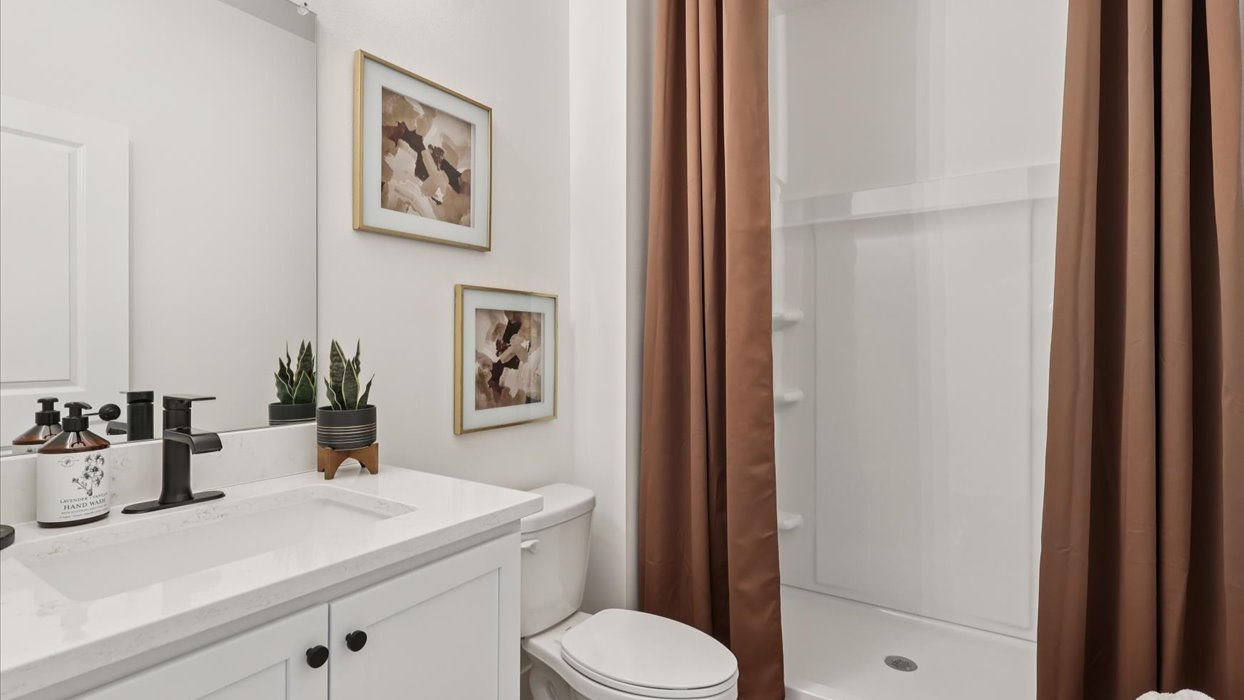 Bathroom with tub and shower combo, quartz countertops, and white vanity