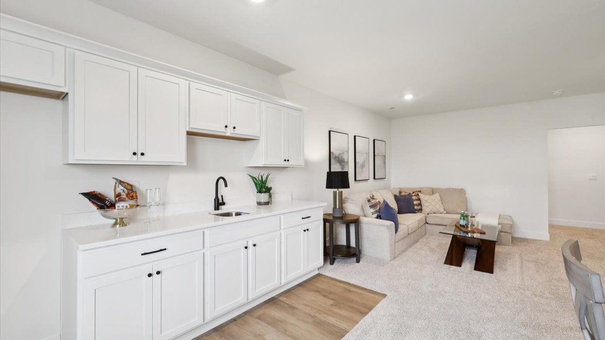 Finished basement living area with comfortable seating space and flexible room for entertaining or relaxing.