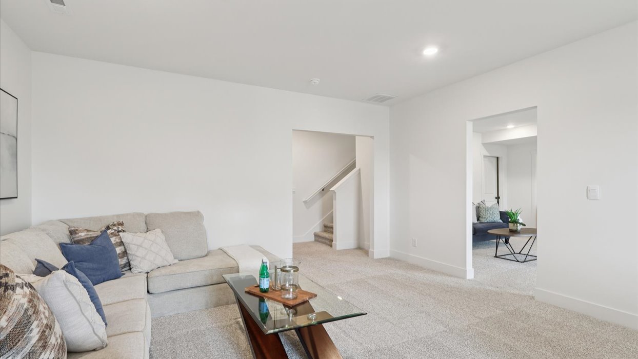 Finished basement living area with comfortable seating space and flexible room for entertaining or relaxing.