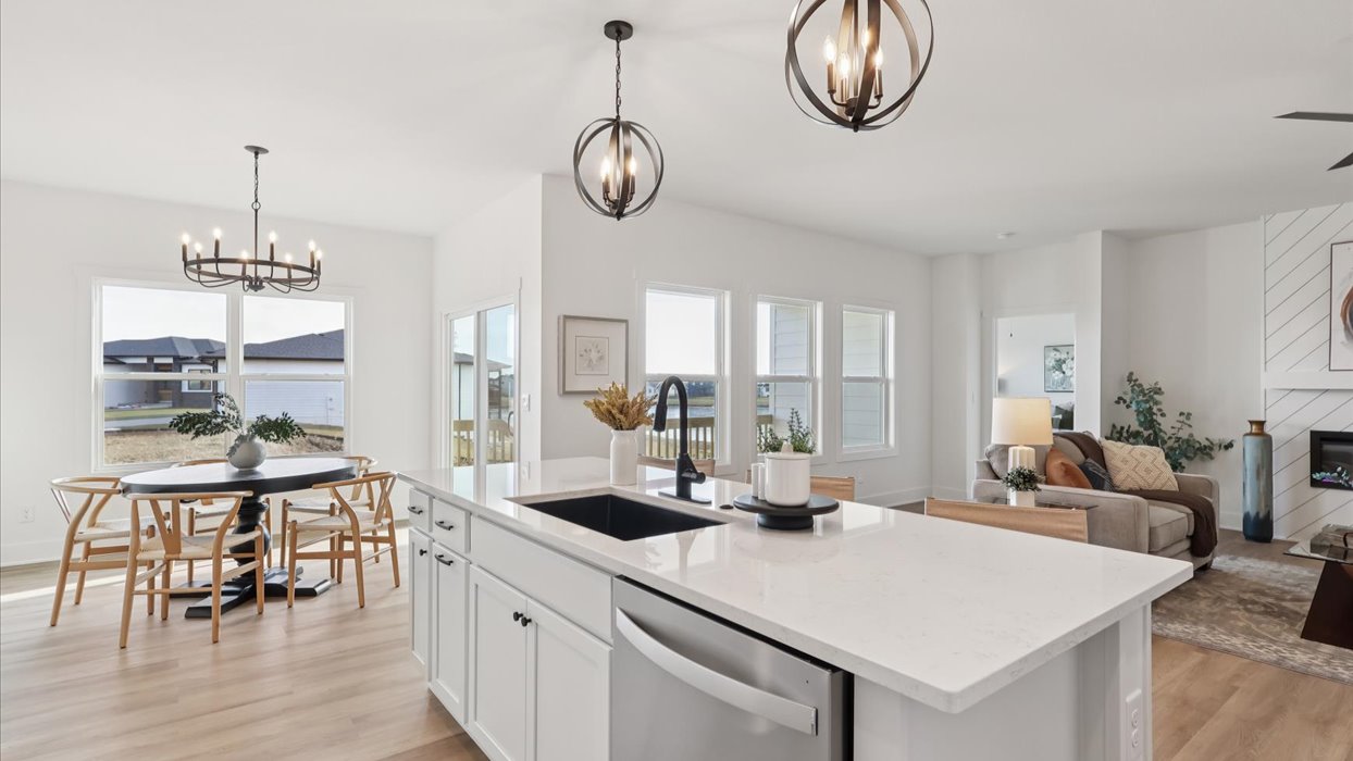 Kitchen with stainless steel appliances, quartz countertops, and white cabinetry