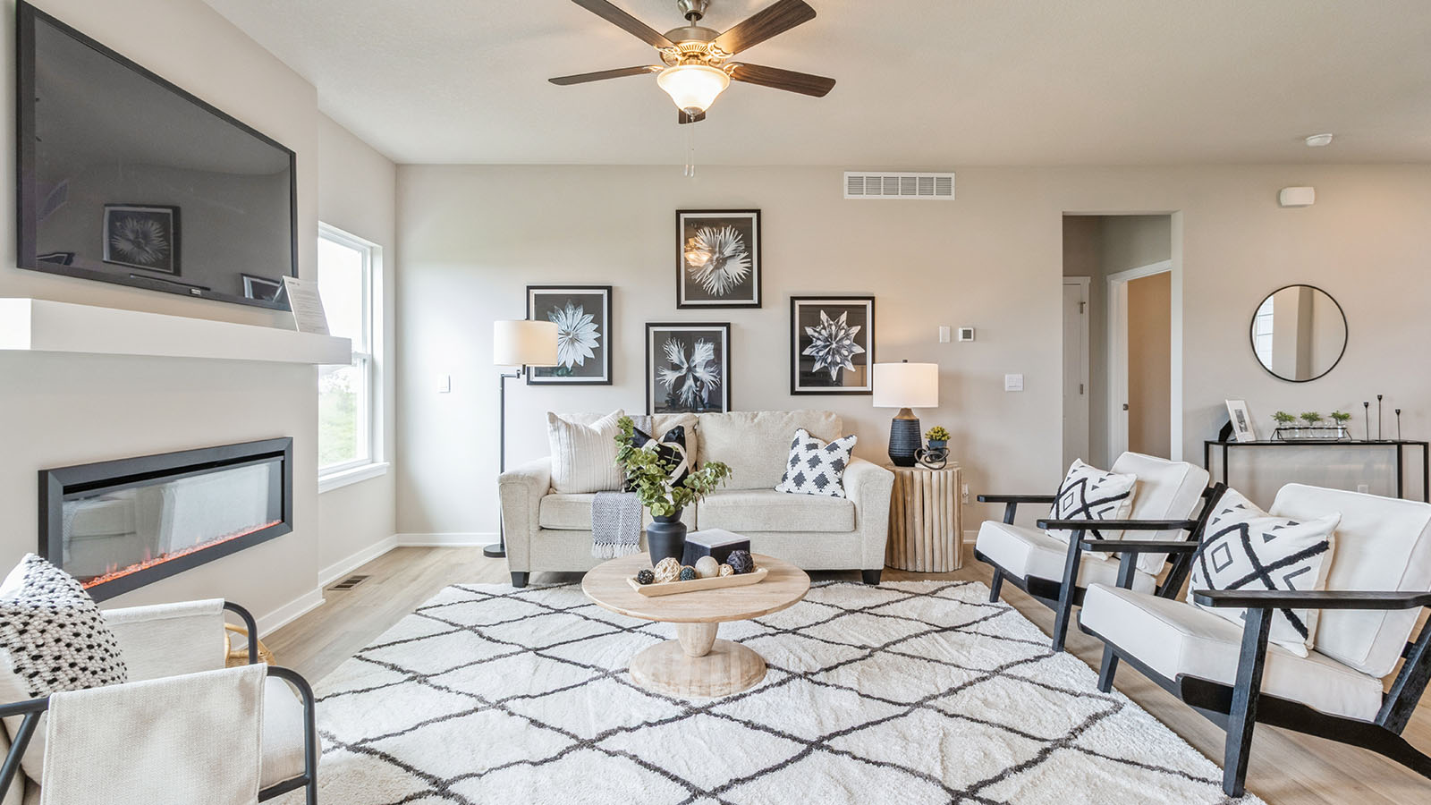reagan living room with electric fireplace and ceiling fan
