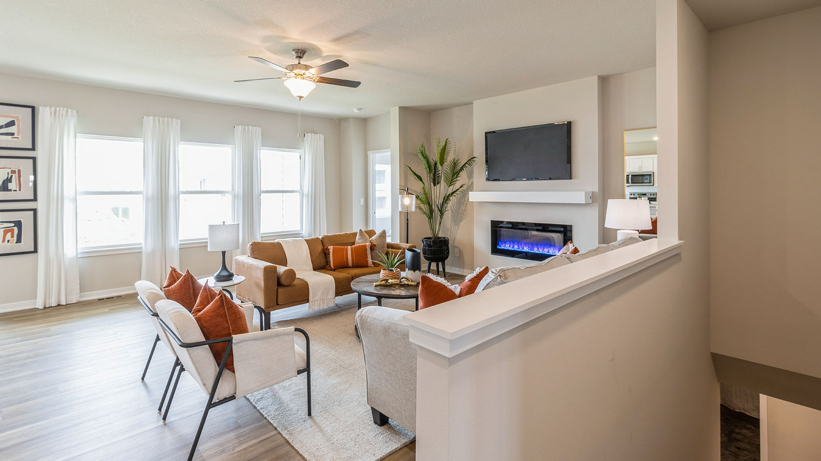 living room with three windows that flood the room with natural light
