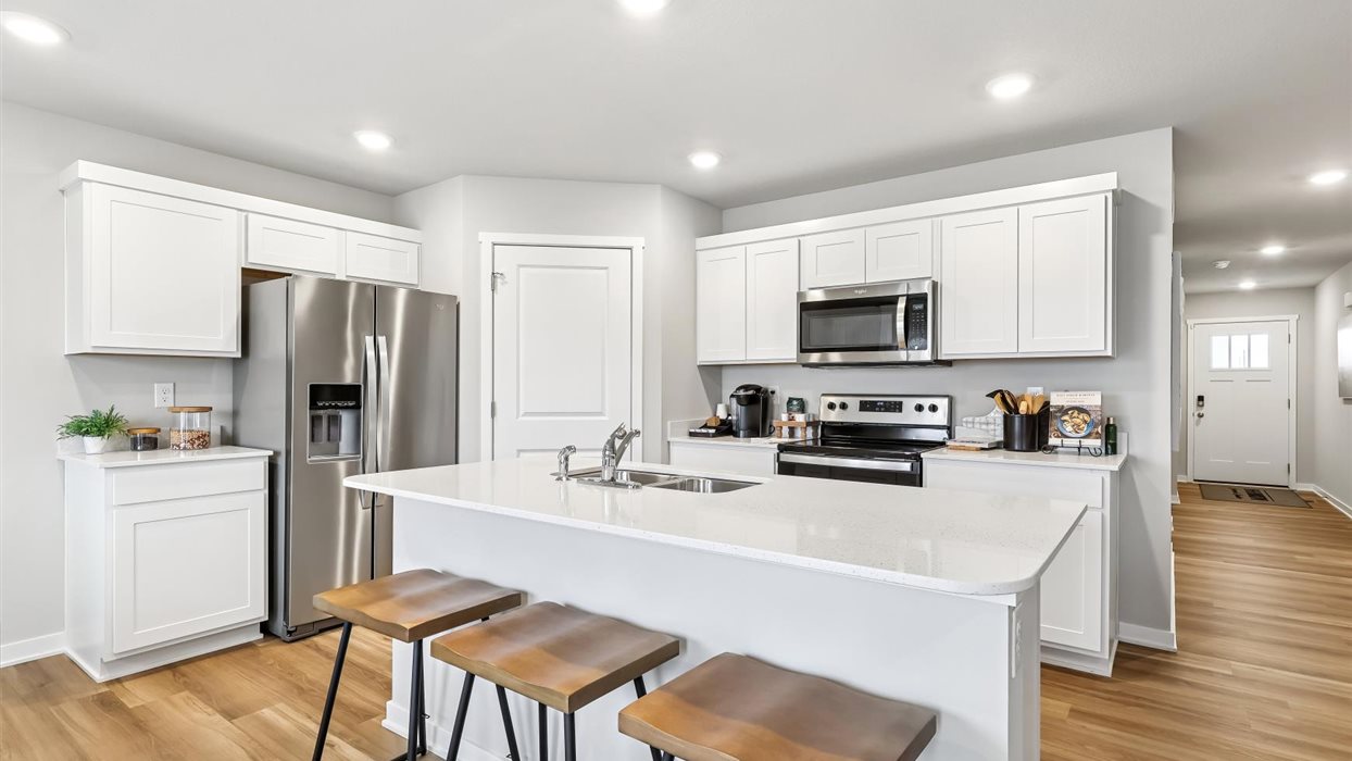 kitchen with white cabinets and island with quartz countertops