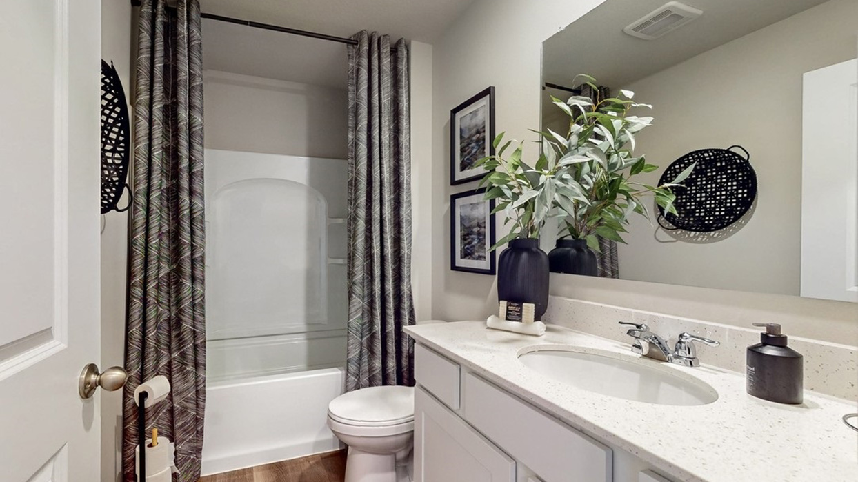 Stylish full bathroom with bright lighting and functional design.
