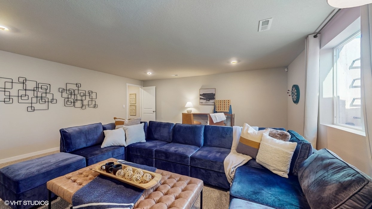Finished basement living area with comfortable seating space and flexible room for entertaining or relaxing.