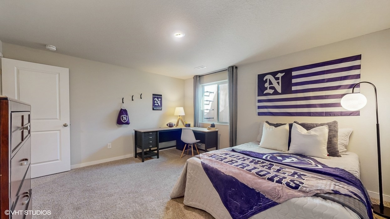 Private lower-level bedroom with natural light and functional storage space.