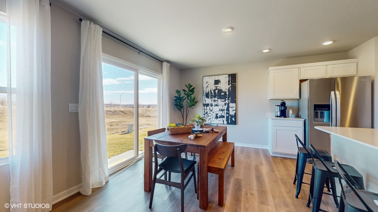Open concept dining space with access to backyard