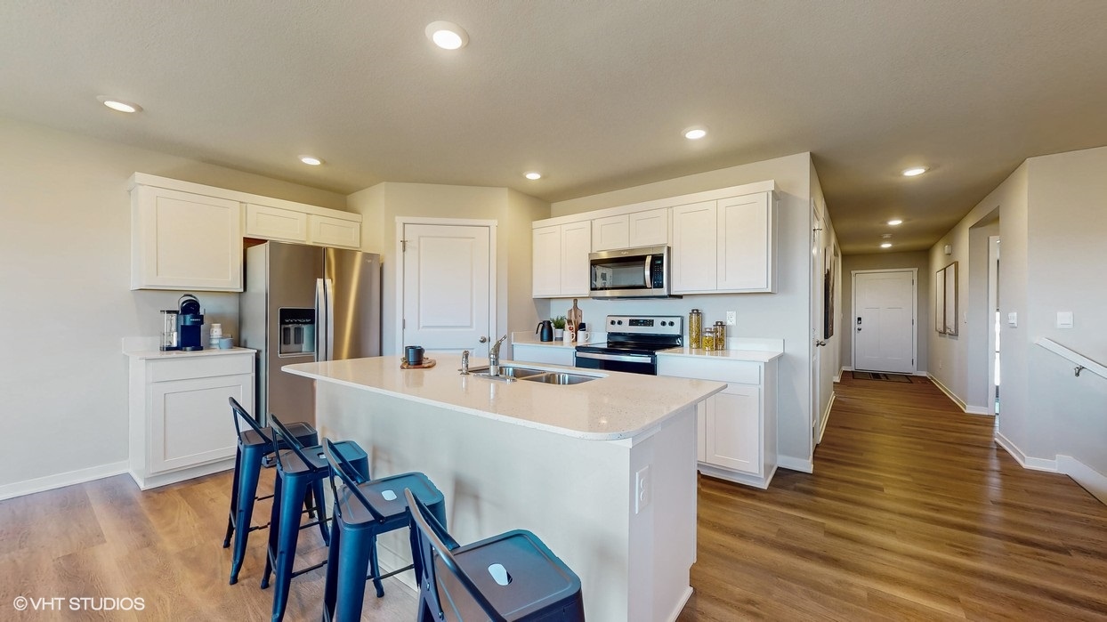 Kitchen with white cabinetry and quartz countertop