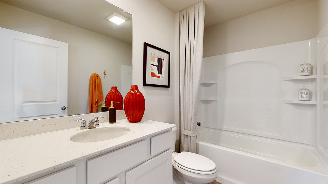 Stylish full bathroom with bright lighting and functional design.