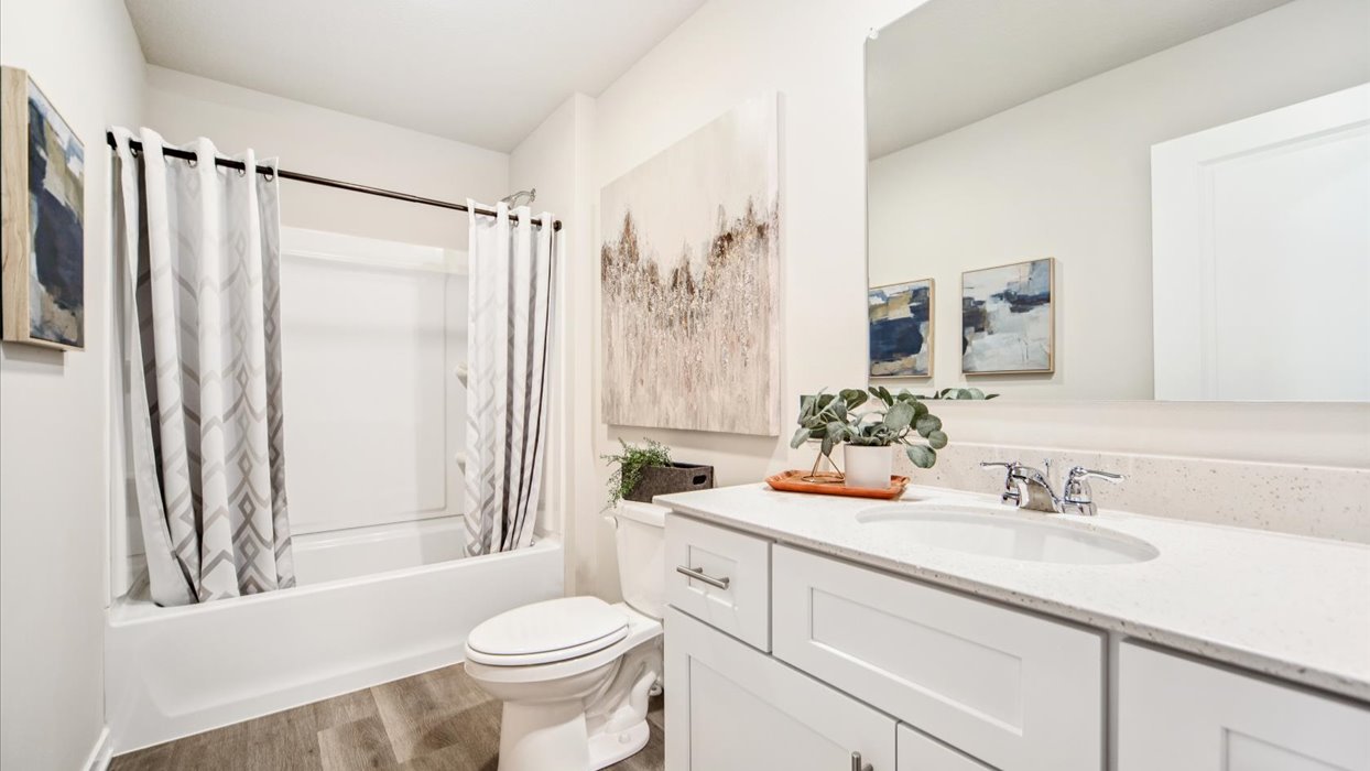 Stylish full bathroom with bright lighting and functional design.
